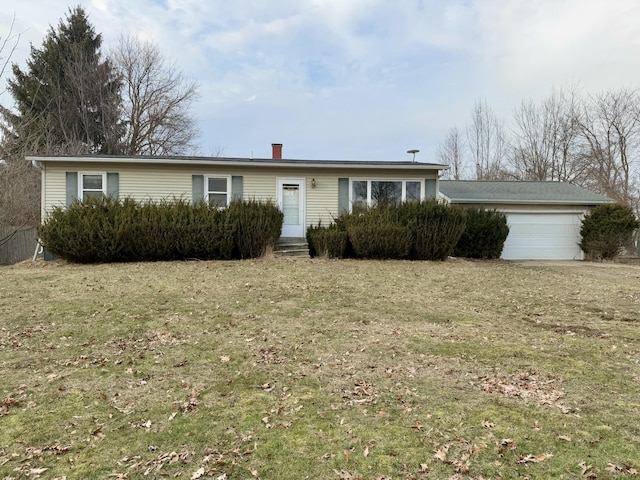 ranch-style house featuring an attached garage and a front lawn