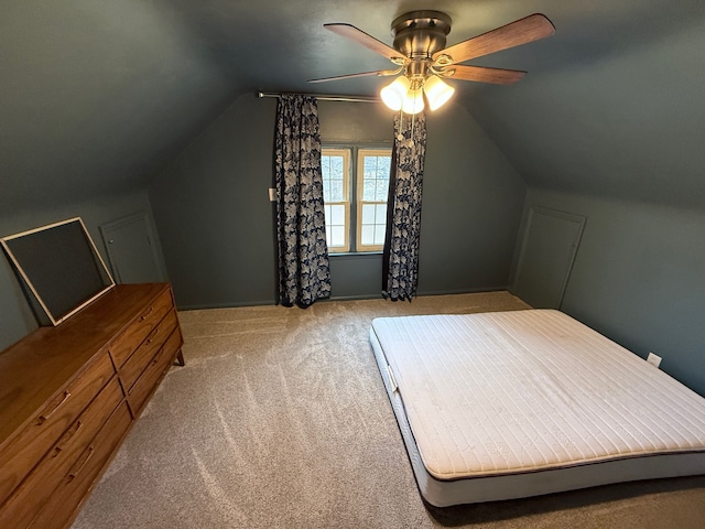 bedroom with vaulted ceiling, carpet, and a ceiling fan