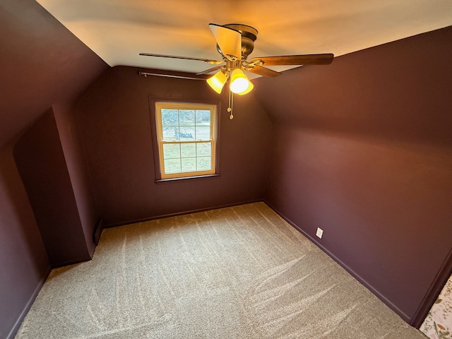 additional living space featuring a ceiling fan, lofted ceiling, baseboards, and carpet