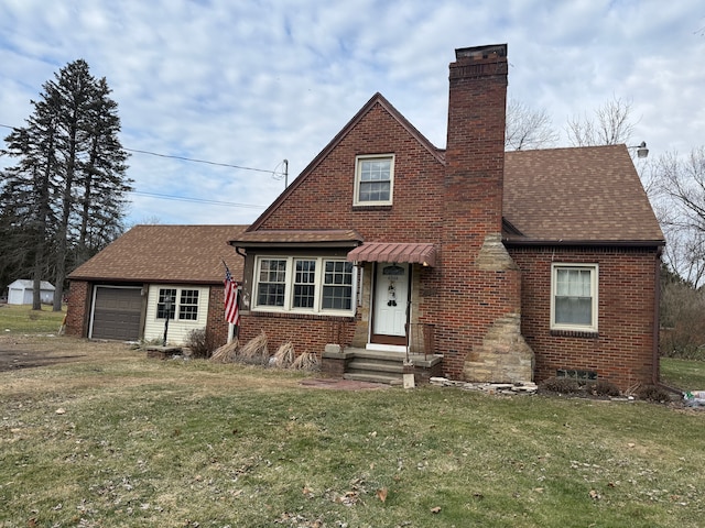 view of front of property with entry steps, a chimney, a front lawn, and brick siding