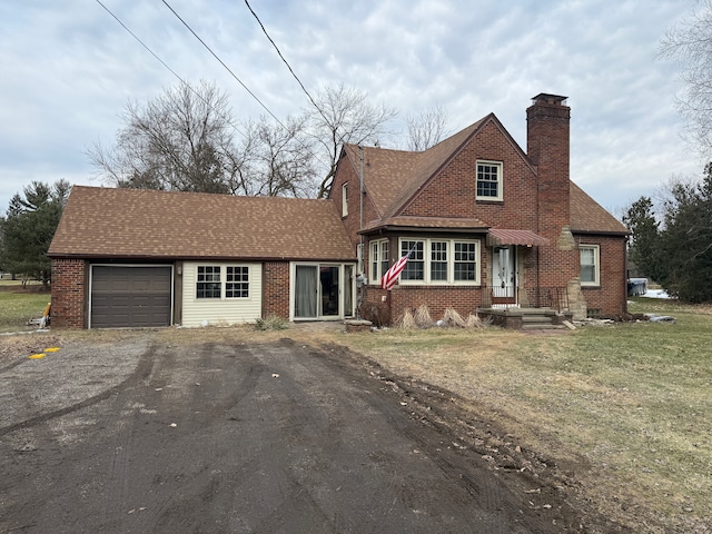 view of front facade with a garage, driveway, a shingled roof, a chimney, and brick siding