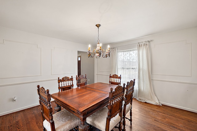 dining room with baseboards, an inviting chandelier, and wood finished floors