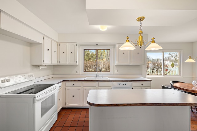 kitchen featuring white appliances, a sink, a wealth of natural light, and white cabinetry