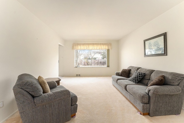 living area with visible vents and light colored carpet