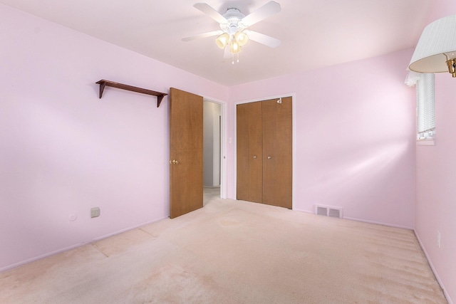 interior space featuring carpet, a closet, visible vents, and ceiling fan