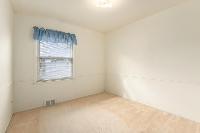 carpeted empty room with visible vents