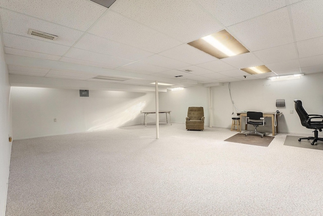 carpeted office space with a paneled ceiling and visible vents