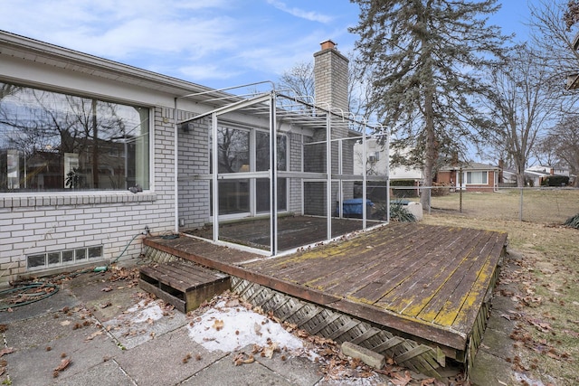 deck featuring fence and a sunroom