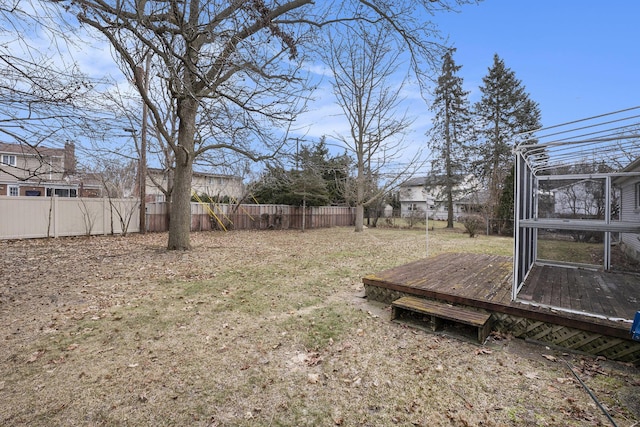 view of yard with a fenced backyard and a wooden deck