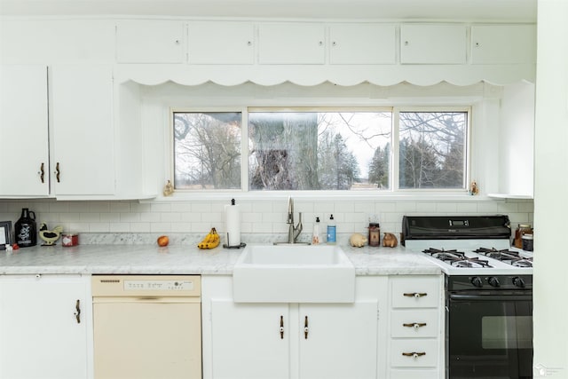 kitchen with a sink, white cabinets, backsplash, dishwasher, and gas range oven