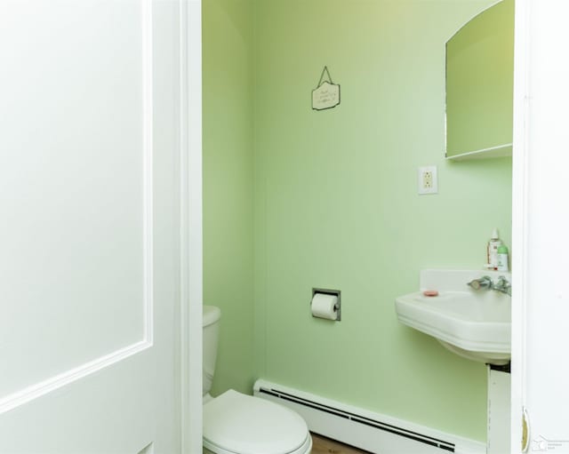 bathroom featuring toilet and a baseboard heating unit