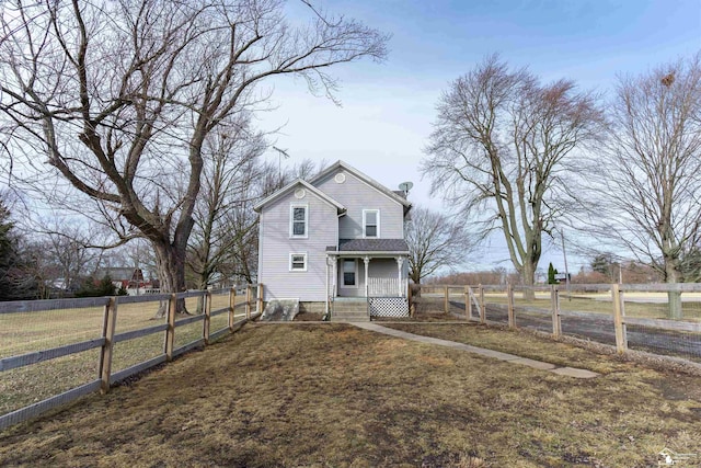 view of front of house with a front yard, a gate, and fence