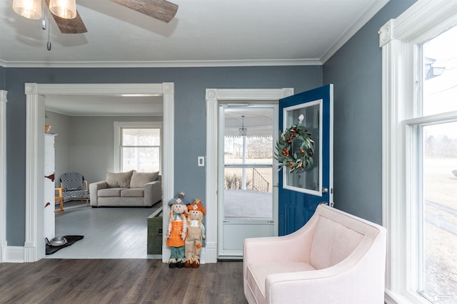 living area featuring ceiling fan, crown molding, and wood finished floors