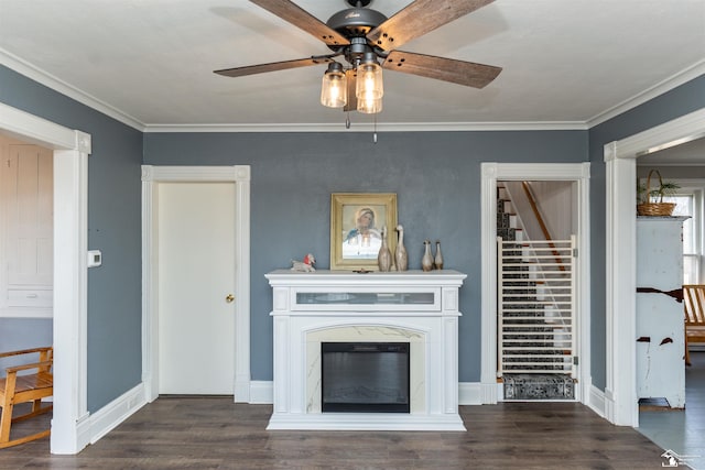 unfurnished living room with stairway, ornamental molding, wood finished floors, and a high end fireplace