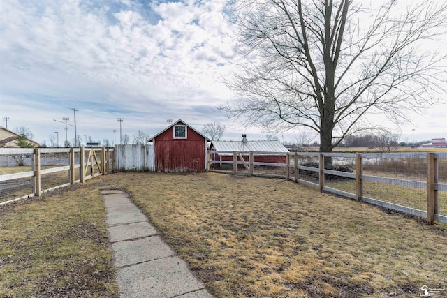 view of yard featuring fence and an outdoor structure