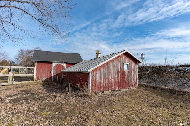 view of shed featuring fence