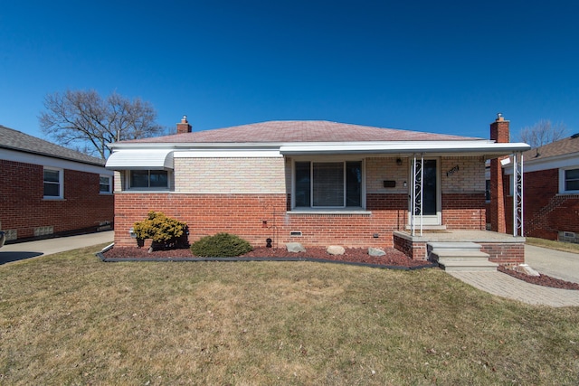 bungalow-style house featuring a front yard, covered porch, brick siding, and a chimney