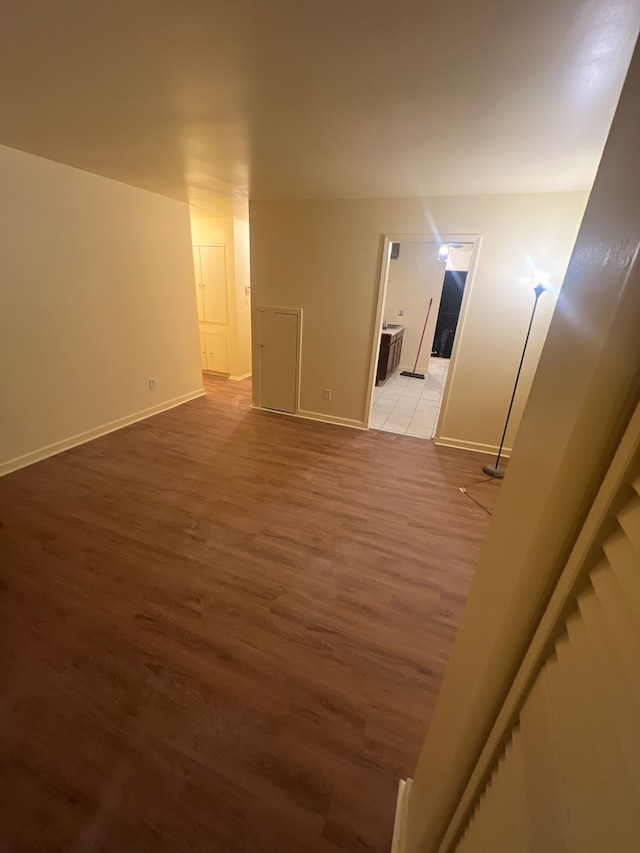 spare room featuring wood finished floors and baseboards