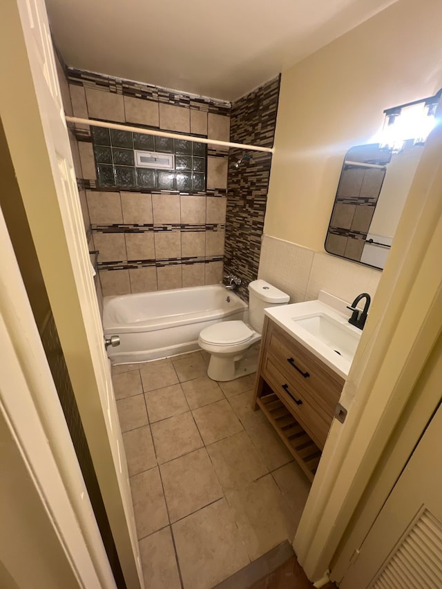 full bathroom with toilet, shower / bathtub combination, tile patterned flooring, vanity, and tile walls