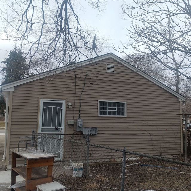 view of side of home featuring fence