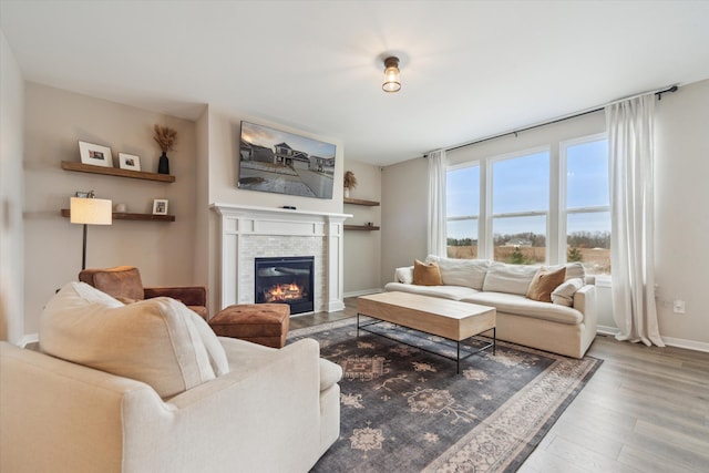 135 Barnsley Dr, Howell, MI 48843 - living room with baseboards, wood finished floors, and a glass covered fireplace