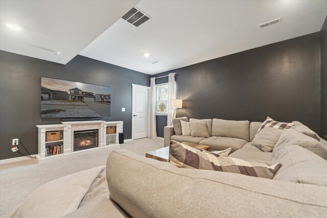 135 Barnsley Dr, Howell, MI 48843 - living area featuring an accent wall, carpet flooring, and visible vents