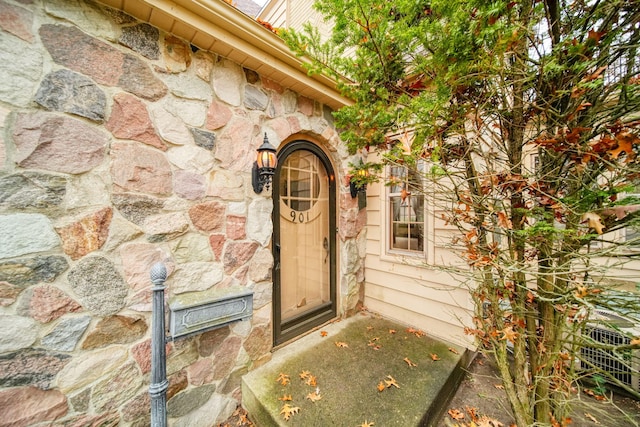 property entrance with stone siding