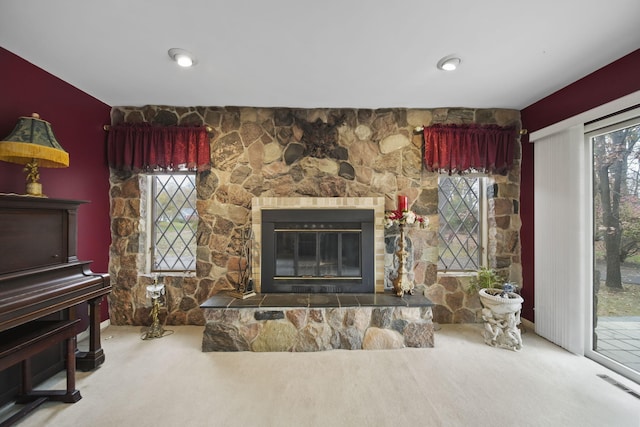 living room with carpet, a fireplace, and a wealth of natural light