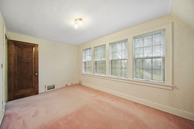 empty room featuring baseboards, carpet, visible vents, and wallpapered walls