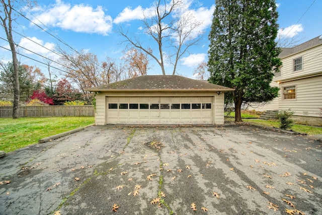 detached garage featuring fence