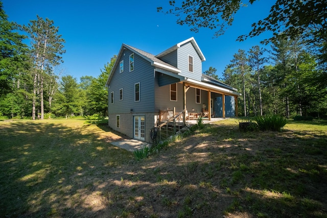 view of home's exterior featuring french doors and a lawn