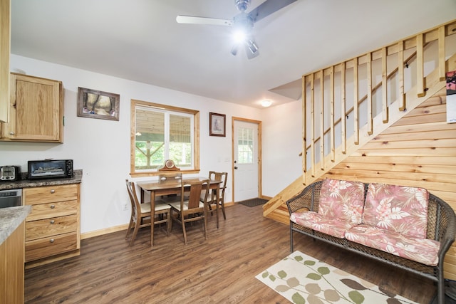 living room featuring a ceiling fan, stairs, baseboards, and dark wood-style flooring