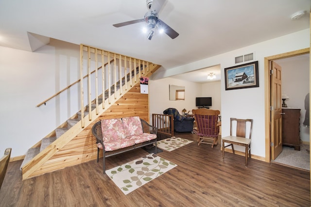 living room featuring visible vents, stairway, a ceiling fan, wood finished floors, and baseboards