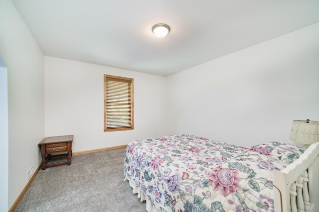 bedroom with carpet floors and baseboards