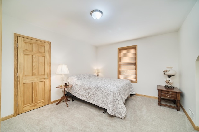 carpeted bedroom featuring baseboards