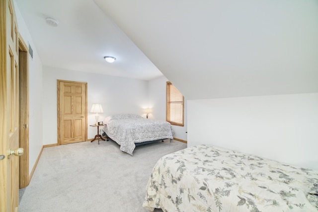 bedroom with lofted ceiling, carpet, visible vents, and baseboards