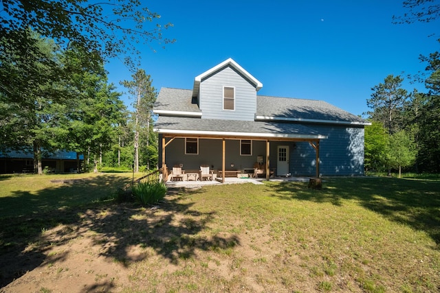 back of house with a yard, roof with shingles, and a patio