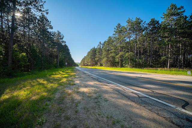 view of street featuring a forest view