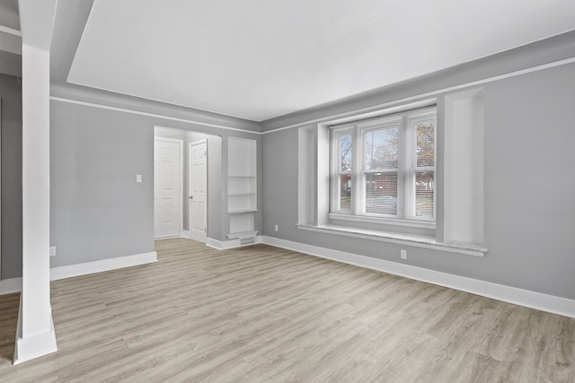 interior space with visible vents, baseboards, and wood finished floors