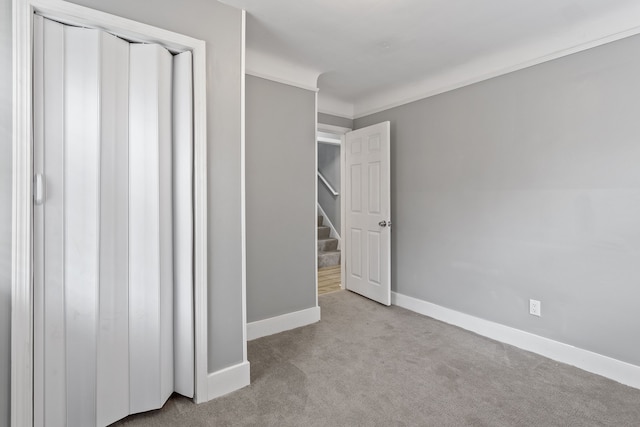 unfurnished bedroom with carpet floors and baseboards