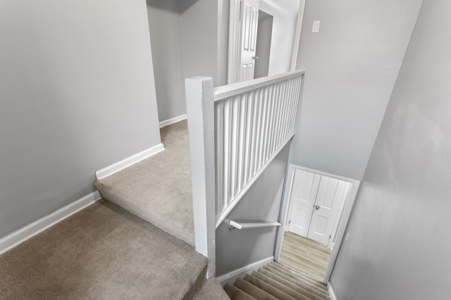 stairs with carpet and baseboards