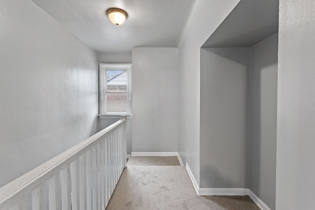 hall with wainscoting, carpet, and baseboards