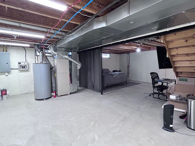 unfinished basement featuring electric panel, heating unit, and water heater