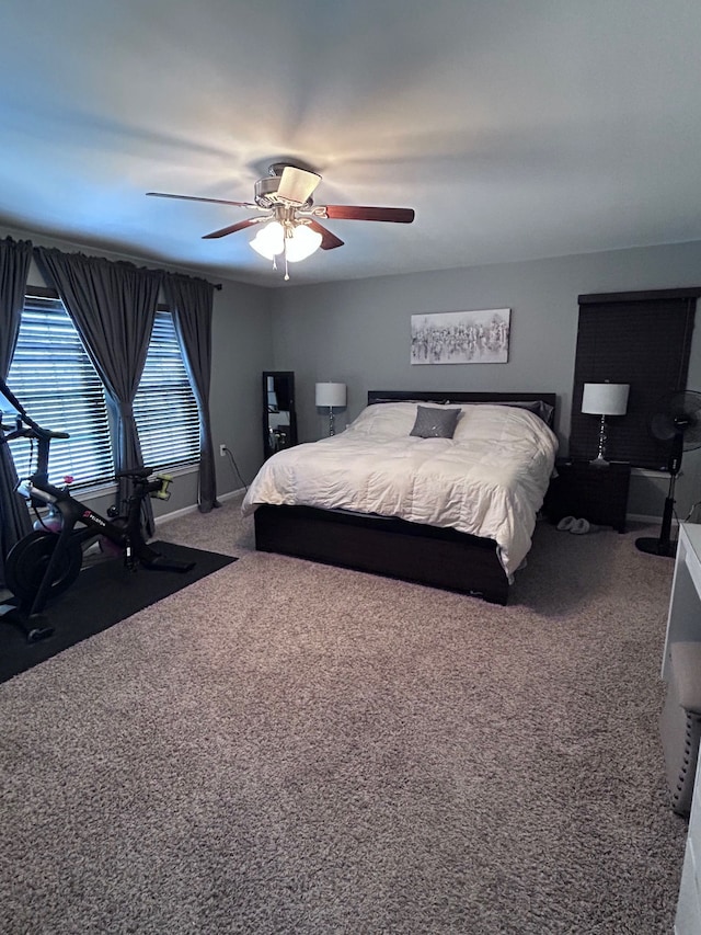 bedroom with carpet flooring, a ceiling fan, and baseboards