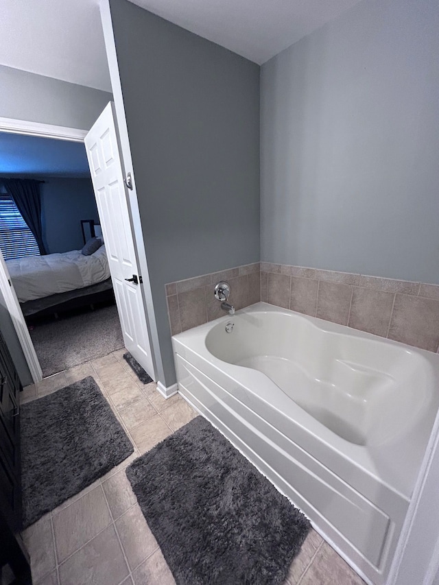 ensuite bathroom with tile patterned flooring, a garden tub, and connected bathroom