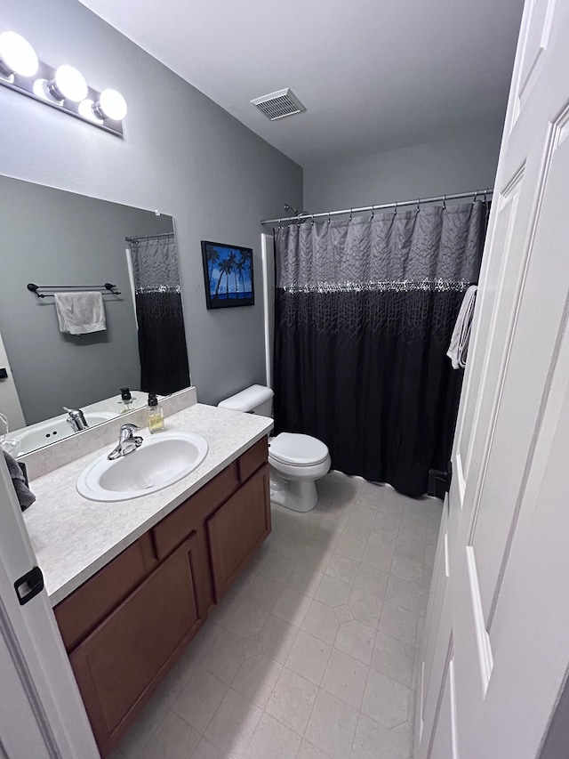 bathroom with curtained shower, tile patterned flooring, toilet, vanity, and visible vents