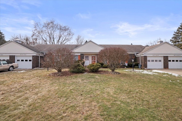 single story home with a garage, brick siding, and a front yard