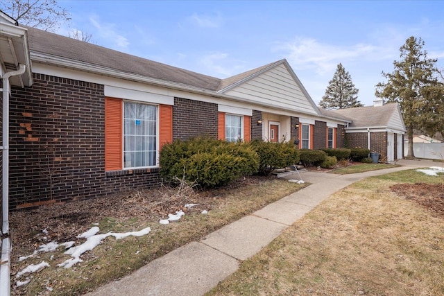 single story home featuring brick siding