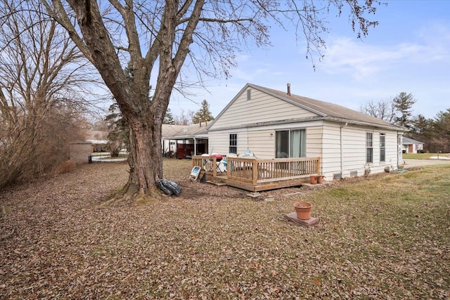 view of side of home featuring a lawn and a wooden deck