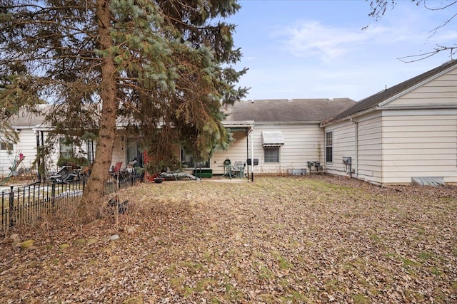 rear view of property featuring fence